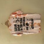 T-shirt in tie dye arancione, scritta nera sul retro